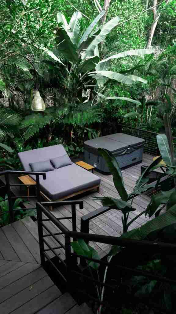Outdoor hot tub at Munduk Cabins surrounded by jungle views — a cozy wellness retreat moment featured on Bohemian Bela.