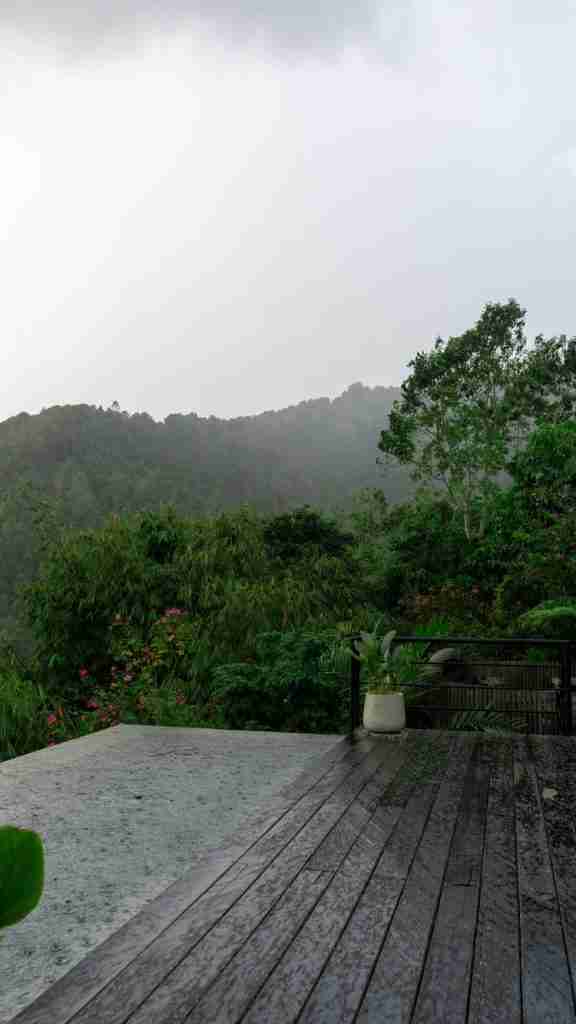 Rainfall gently hitting the pool at Munduk Cabins, Bali — a peaceful jungle moment during a moody mountain retreat on Bohemian Bela.