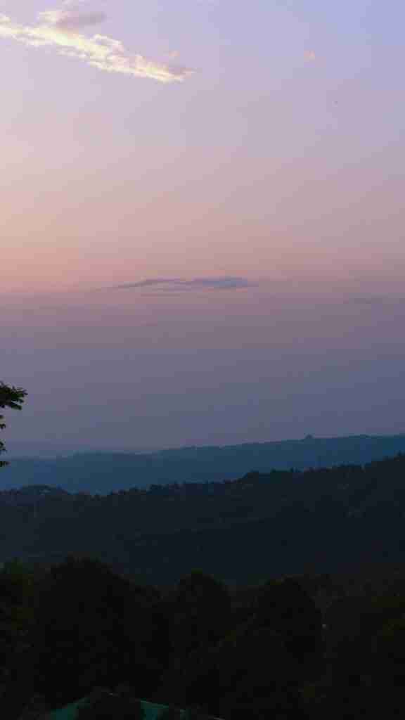 Golden hour sunset over the mountains at Munduk Cabins, Bali — dreamy twilight views from Bohemian Bela’s jungle escape.
