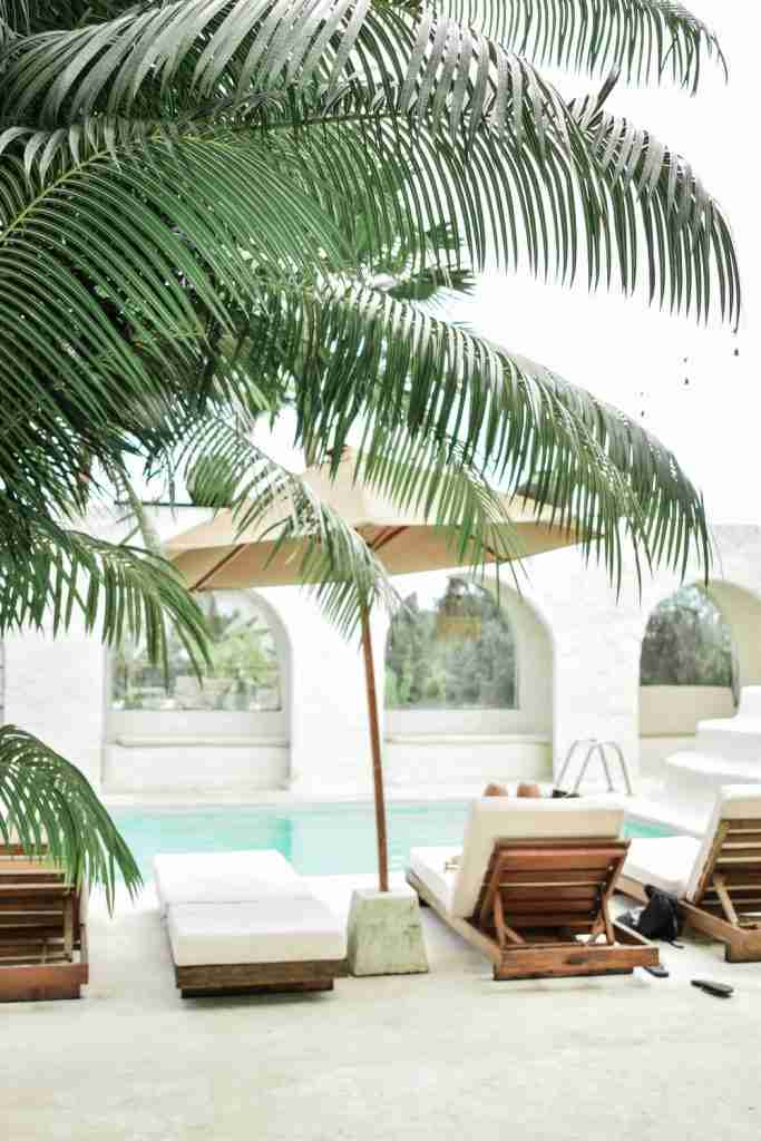 Stylish outdoor lounge area at Hotel Sages in Canggu, Bali, featuring comfortable seating and a laid-back vibe, perfect for enjoying the tropical climate.